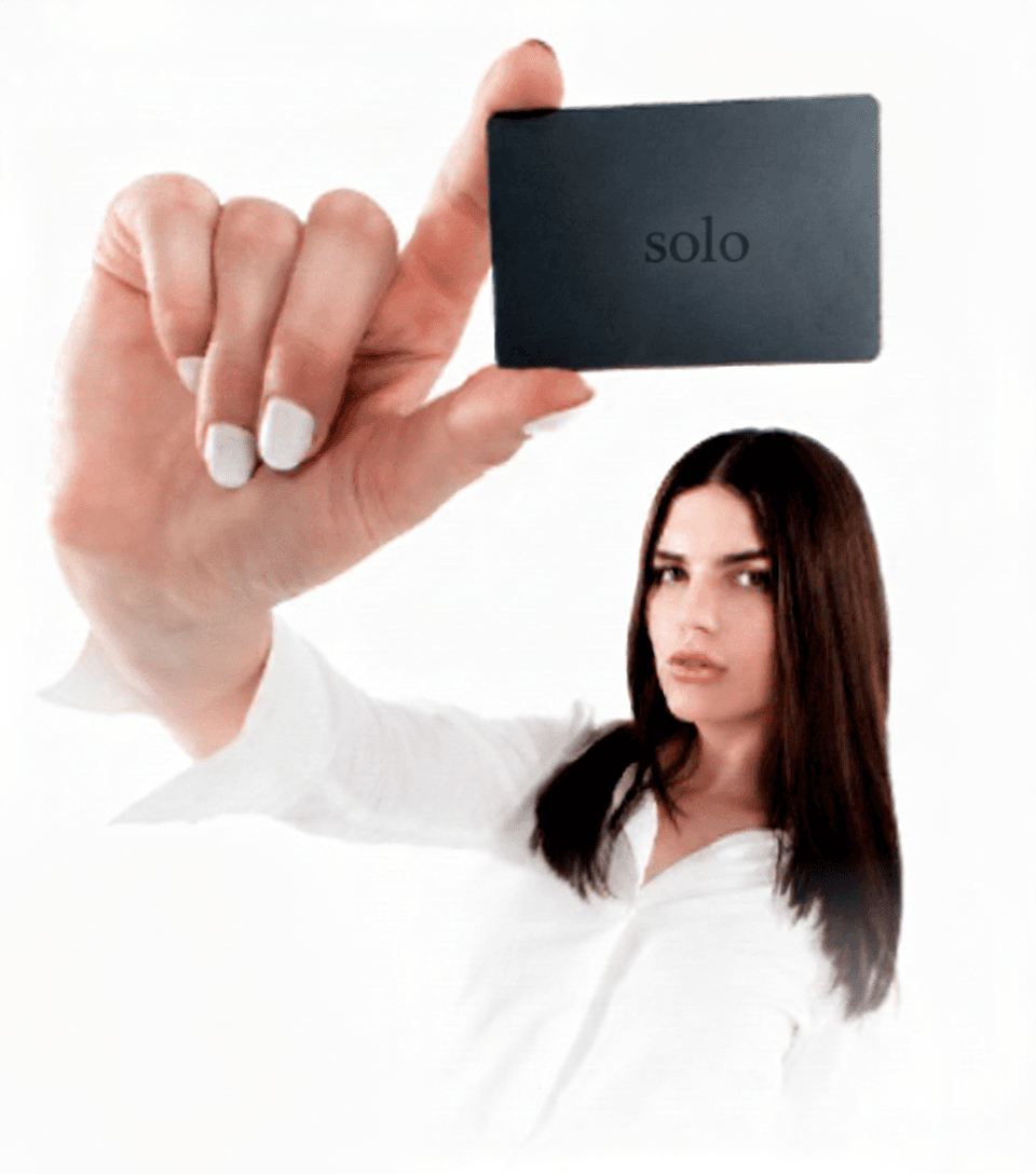 Woman holding 'solo' card
